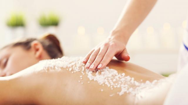 Picture of beautiful woman getting exfoliation treatment in spa